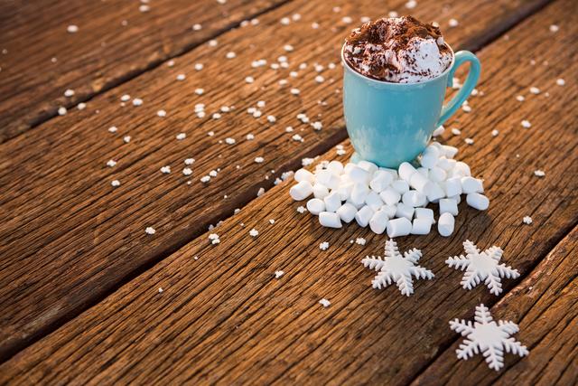 Cup of coffee with snowflake and marshmallow on wooden plank - Download Free Stock Photos Pikwizard.com