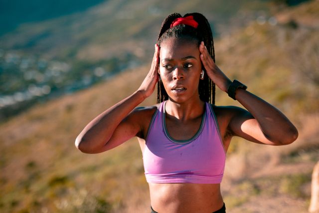 Fit african american woman exercising in countryside at sunset, wearing wireless earphones - Download Free Stock Photos Pikwizard.com