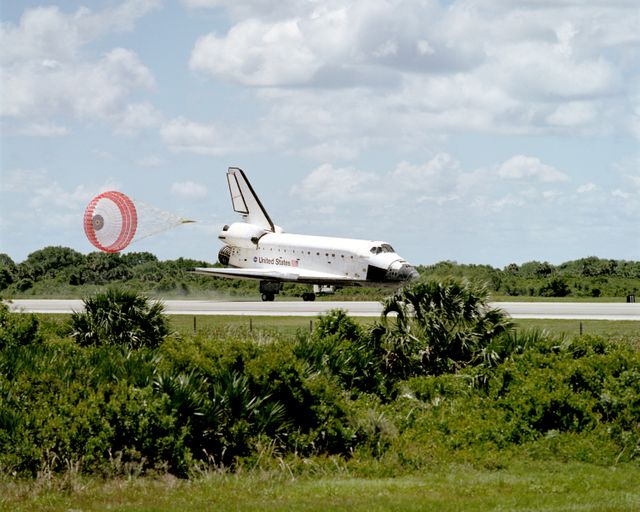 STS110-S-055 (19 April 2002) --- With its drag chute gear deployed, the Space Shuttle Atlantis eases to a stop on the runway at the KSC landing facility to complete the nearly 11-day STS-110 journey.   Astronaut Michael J. Bloomfield, mission commander, eased Atlantis to a textbook landing on runway 3-3 at the Florida spaceport at 12:27 p.m. (EDT), April 19,  2002, under clear skies and light winds.   The landing completed a 4.5-million-mile mission that saw successful delivery and  installation of the centerpiece of the International Space Station?s main truss and the inaugural run of the first space railcar, the Mobile Transporter.