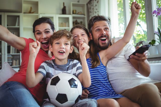 Excited family watching football match - Download Free Stock Photos Pikwizard.com