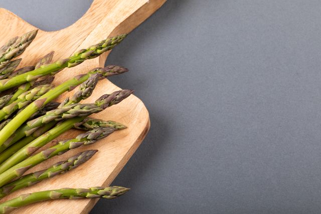 High angle view of asparagus on cutting board over gray background, copy space - Download Free Stock Photos Pikwizard.com