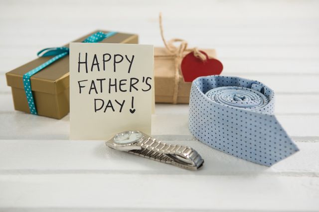 Close up of fathers day greeting card by gifts on table - Download Free Stock Photos Pikwizard.com