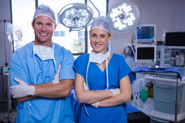 Portrait of male and female nurse standing in operation theater - Download Free Stock Photos Pikwizard.com