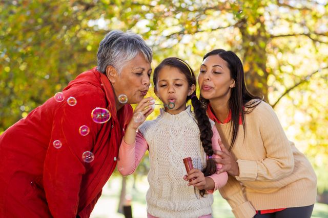 Daughter with mother and grandmother blowing bubbles - Download Free Stock Photos Pikwizard.com