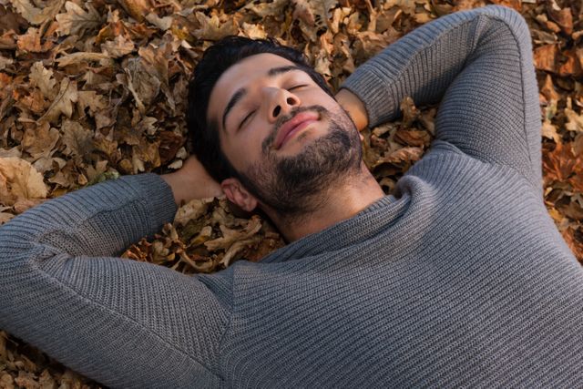 Man sleeping on autumn leaves - Download Free Stock Photos Pikwizard.com