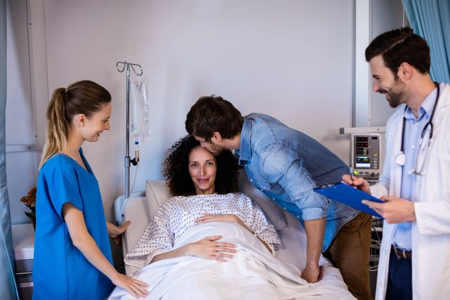 Man kissing pregnant woman on her forehead in the ward - Download Free Stock Photos Pikwizard.com