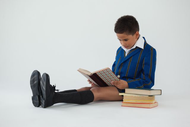 Schoolboy reading book on white background - Download Free Stock Photos Pikwizard.com