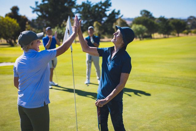 Two happy caucasian senior women at golf course high fiving after their game - Download Free Stock Photos Pikwizard.com