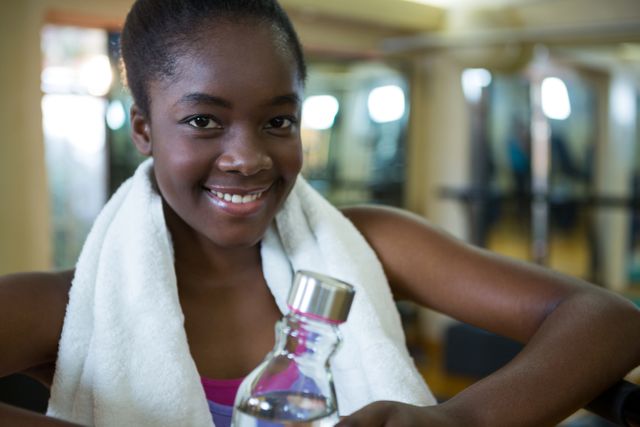 Portrait of happy woman holding water bottle after workout - Download Free Stock Photos Pikwizard.com