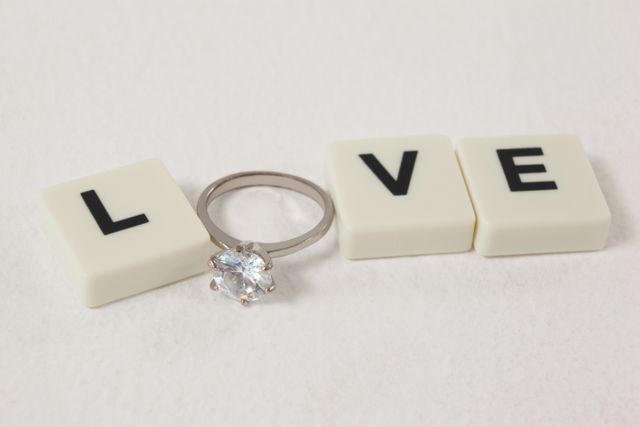 Diamond ring between white blocks displaying love message - Download Free Stock Photos Pikwizard.com