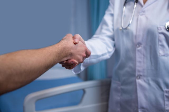 Mid section of nurse and doctor shaking hands - Download Free Stock Photos Pikwizard.com