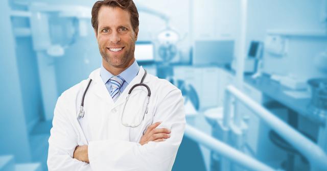 Dentist standing with arms crossed against clinic in background - Download Free Stock Photos Pikwizard.com
