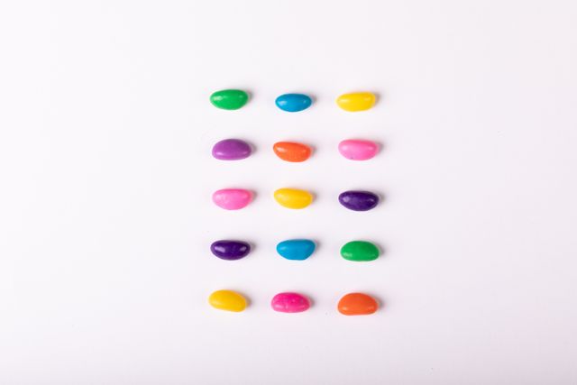 Directly above shot of colorful candies over white background, copy space - Download Free Stock Photos Pikwizard.com