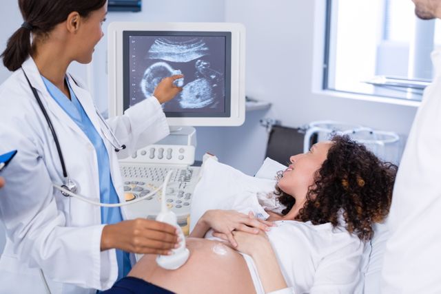 Doctor doing ultrasound scan for pregnant woman - Download Free Stock Photos Pikwizard.com