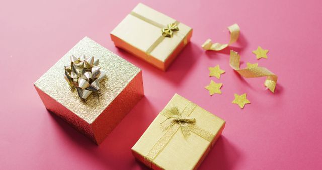 Image of wrapped gold presents and stars on pink background - Download Free Stock Photos Pikwizard.com