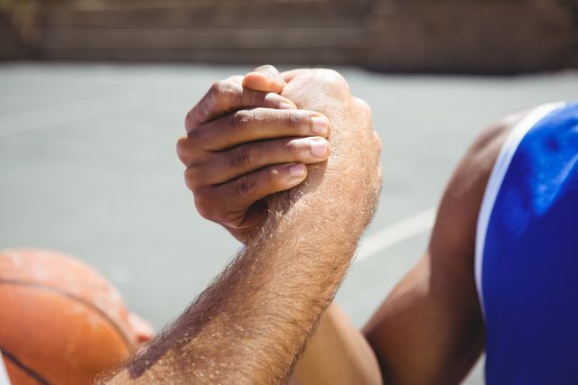 Cropped image of basketball players holding hands - Download Free Stock Photos Pikwizard.com
