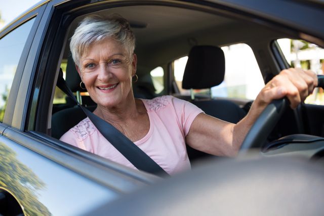 Happy senior woman driving a car - Download Free Stock Photos Pikwizard.com