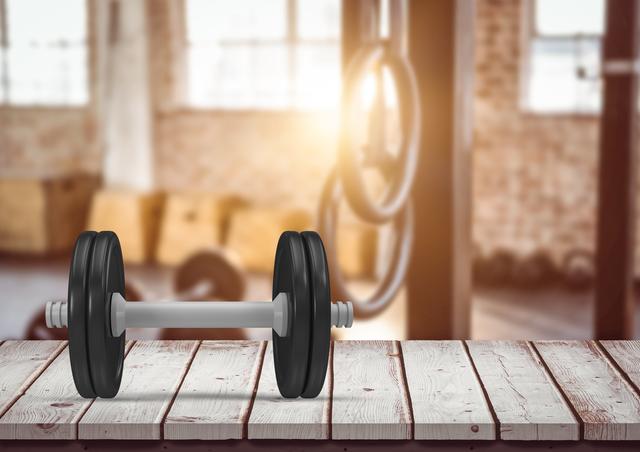 Dumbbell on a wooden plank in the gym - Download Free Stock Photos Pikwizard.com