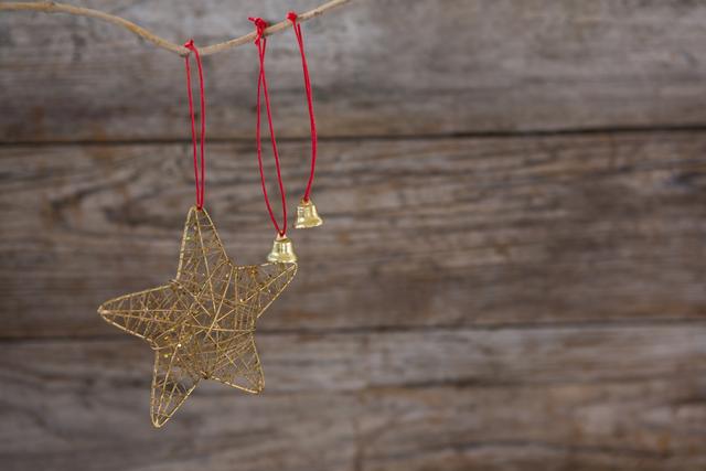 Christmas bell and star hanging against wooden wall - Download Free Stock Photos Pikwizard.com