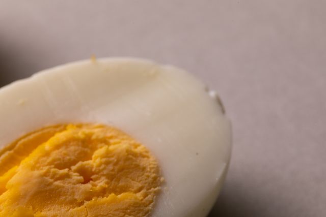 Close-up of halved boiled egg on white background, copy space - Download Free Stock Photos Pikwizard.com
