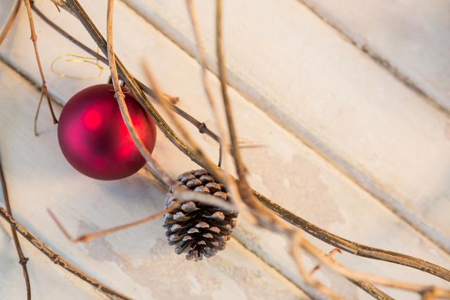 Christmas bauble ball and pine cone on wooden plank - Download Free Stock Photos Pikwizard.com