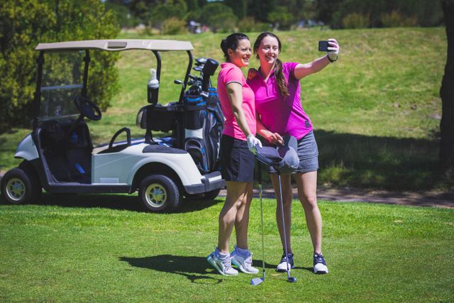 Two caucasian woman taking a selfie at golf course on a bright sunny day - Download Free Stock Photos Pikwizard.com