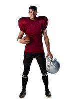 Portrait of smiling woman in American football uniform and helmet. Stock  Photo